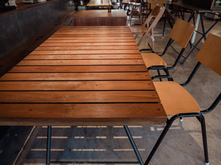 Brown wood plank table with simple wooden chair.