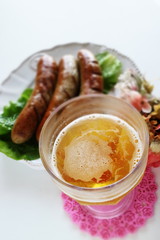 Beef and grilled sausage on white background