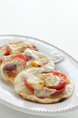 Fusion food, gyoza dough and tomato cheese bake for pizza style