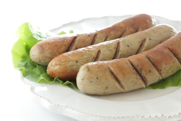 Grilled pork sausage on lettuce with copy space