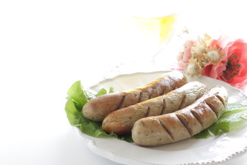 Grilled pork sausage on lettuce with copy space