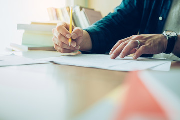 high school,college,university student writing in classroom or library at work space with book stack for knowledge prepare exams scholarship study abroad.research world international education learn