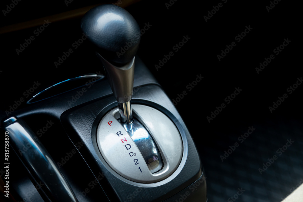 Poster close up of the manual gearbox transmission handle. accelerator handle and buttons in a new car. .