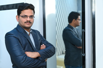 Successful and confidence Man looking himself into mirror