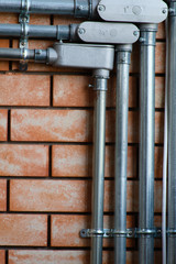 Electrical wiring work in a steel pipe of a house with a loft style decoration design.