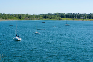 Fototapeta na wymiar Sailing and dragon boats from a distance on fresh water lake