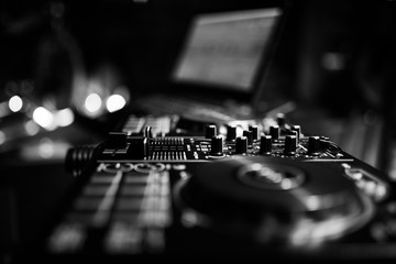 Dj mixes the track in the nightclub at a party