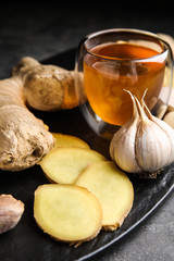 Fresh garlic and other natural cold remedies on grey table