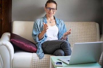 Young pretty european woman with glasses psychologist coach holds an online session on the...