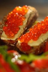Sandwiches. Sliced rye loaf with salmon caviar and butter