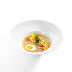 Chicken Soup with Tagliatelle Pasta, Eggs and Fresh Herbs Isolated