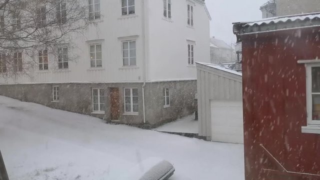 Norwegian urban white wood building number 12, trondheim norway, landscape covered with snowdrift slow motion footage