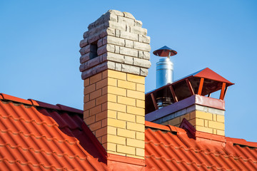 Brick pipe on the roof of a private house.