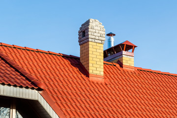 Brick pipe on the roof of a private house.