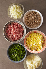 Dumpling meat and vegetable ingredient in bowls 