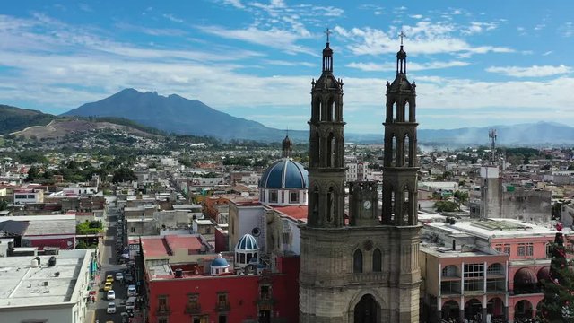 Tepic Cathedral in city centre of Tepic. State Nayarit in Mexico. Catedral de la Purísima Concepción and scenic panorama of Tepic. Aerial drone view, orbiting 4K.