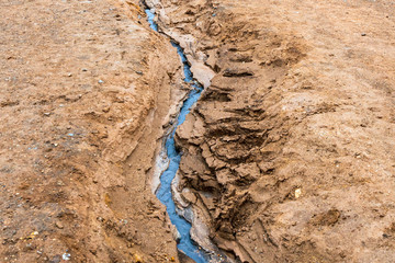 Textured, cracked and patterned mud in the Hverarond/Myvatn area in Icelandic nature. Geothermal and active volcanic ground. Geology and energy concept.