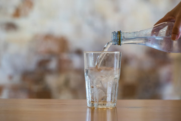 Pouring water from bottle into glass
