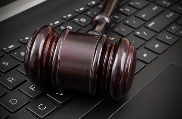 Obraz na płótnie Canvas Gavel on laptop computer, cyber law concept