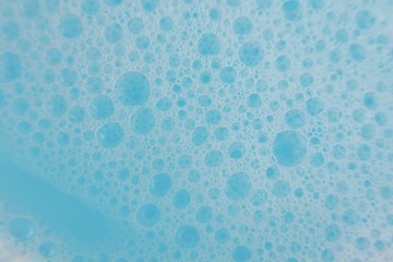blue soap foam macro background.soap bubbles blue pastel color . Detergent texture. Purity and freshness. Bath foam. Ease.Lightness and airiness	