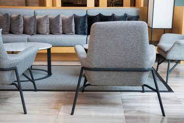 lobby with many pillow on long grey sofa