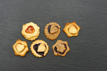 christmas cookies lying on black shale at christmas time