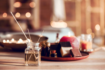 Reed diffuser with cosmetics for spa treatment on table