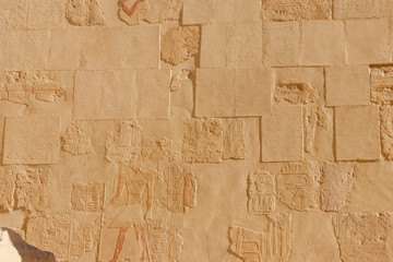 Ancient egyptian paintings and hieroglyphs on a wall in Mortuary temple of Hatshepsut in Luxor,...