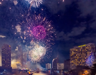 Obraz na płótnie Canvas Celebration of New year day with colorful fireworks on Chao Phraya riverside with Iconsiam building landmark of Bangkok city.