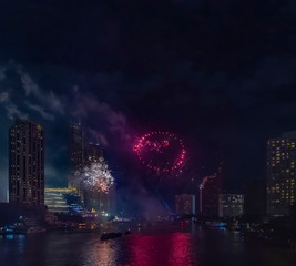 Celebration of New year day with colorful fireworks on Chao Phraya riverside with Iconsiam building landmark of Bangkok city.
