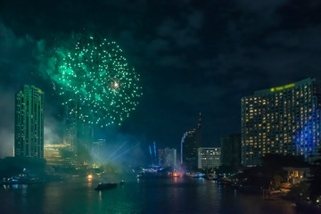 Celebration of New year day with colorful fireworks on Chao Phraya riverside with Iconsiam building landmark of Bangkok city.