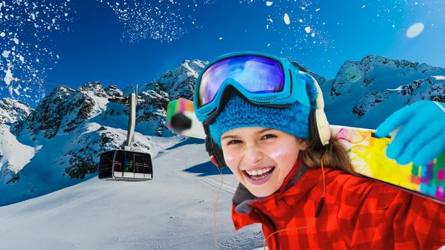 Portrait of happy young in the snow with ski in winter time, cable car and ski slope in the background.