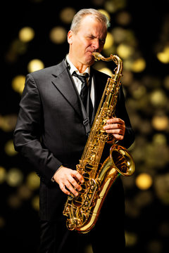 Musician playing saxophone (bokeh reflection background)