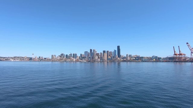 Seattle city coastline panorama with skyscrapers and port cranes