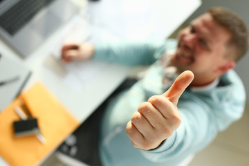 A young designer holds a pen from a tablet in his