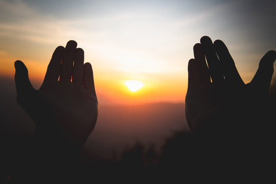 Silhouette of christian man hands praying to god, Man Pray for god blessing to wishing have a better life. begging for forgiveness and believe in goodness, Christian Religion concept background.