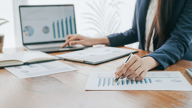 Business concept. Business people discussing the charts and graphs showing the results of their successful teamwork.