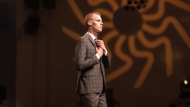 Male Model, Adjusting His Tie During A Fashion Show