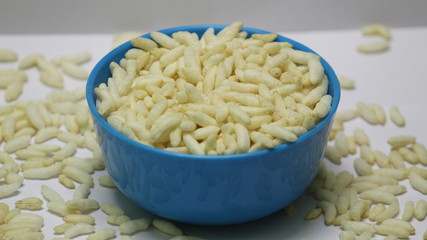 Puffed rice on the blue bowl with white background