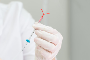 Gynecologist holding an IUD birth control device