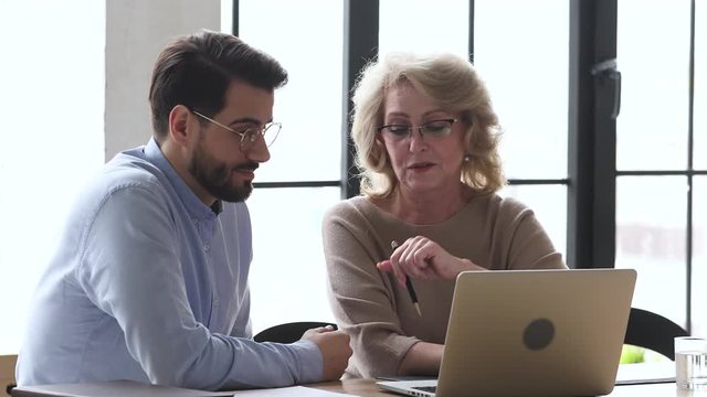 Skilled professional team discuss computer software at business meeting