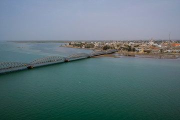 Aerial photo of Senegal river in Sant Louis, Senegal, with the Faidherbe bridge seen connecting the...