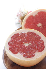 Cut fruit, red ruby grapefruit on dish for healthy dessert