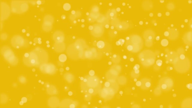 Bright animated golden yellow bokeh background with glowing light particles.