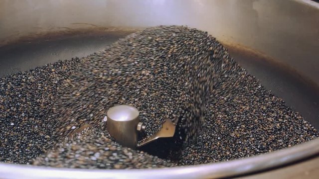 Coffee Beans Spinning in a Large Grinder