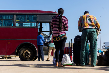 People waiting with luggage to embark on a bus from Dakar to Ziguinchor in Senegal, Africa. Travek...