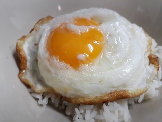 Closed up fried egg and rice in a bowl.  Delicious food for breakfast. Like a heart for valentine day