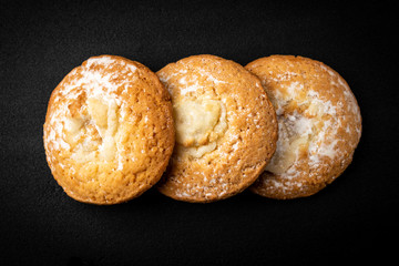 Cottage cheese (cheesecake) cookies on black background.