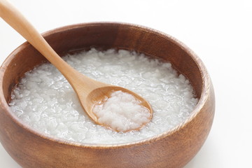 Chinese food, healthy rice congee in wooden bowl