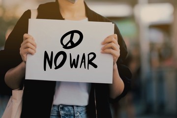 Activists raise anti-war message signs